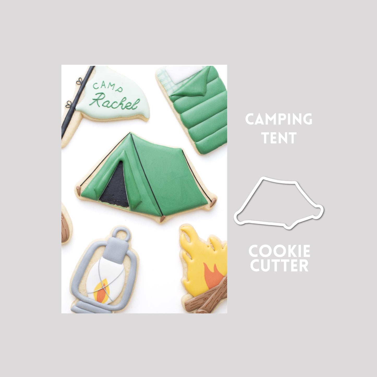 Decorated tent sugar cookie next to a tent cookie cutter outline on a gray background.