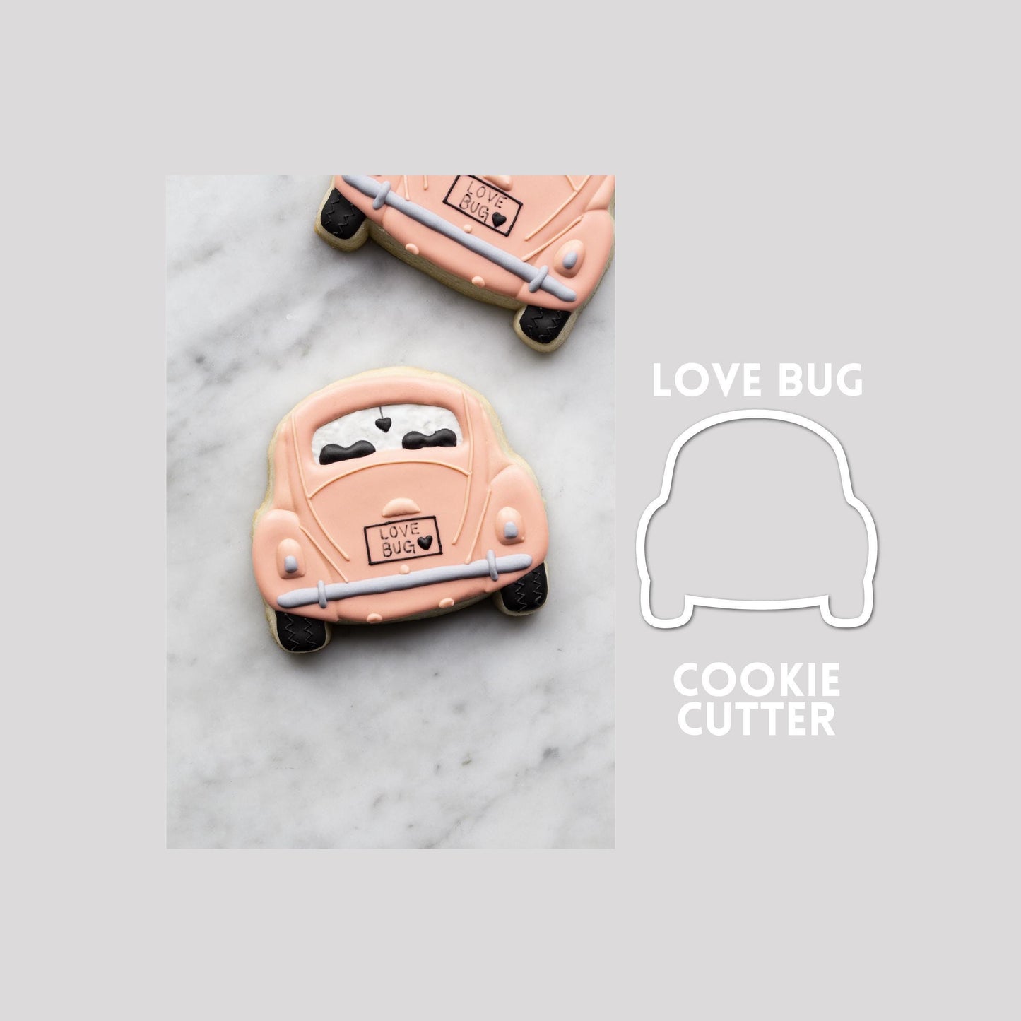 Decorated love bug sugar cookie next to a love bug cookie cutter outline on a gray background.