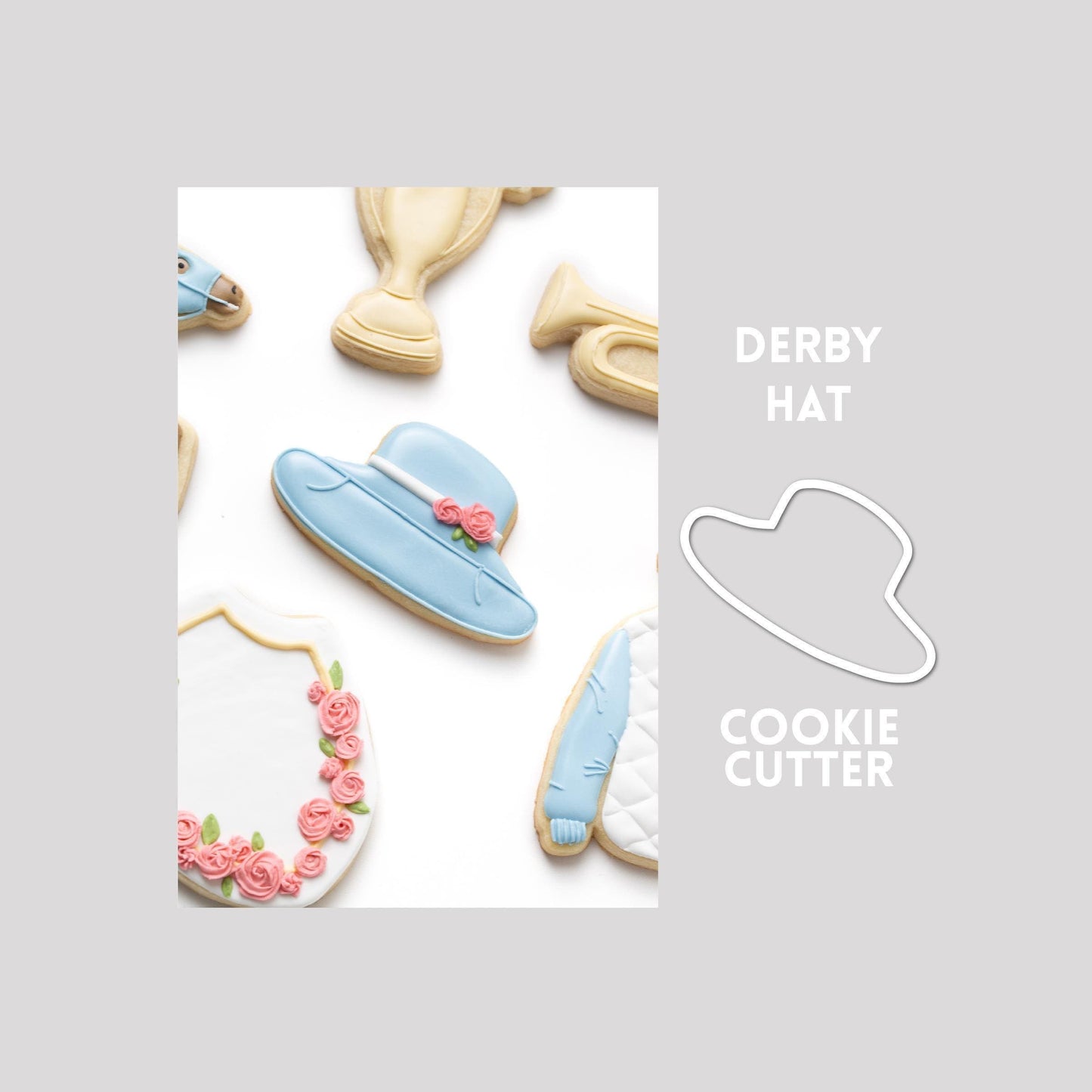 Decorated derby hat sugar cookie next to a derby hat cookie cutter outline on a gray background.
