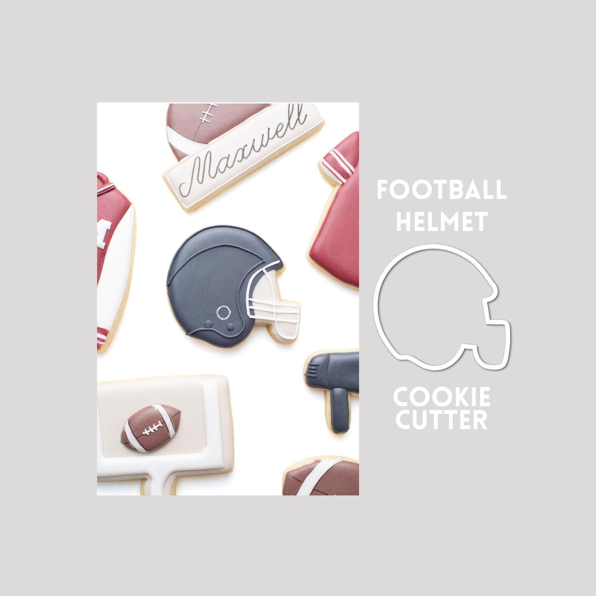 Decorated football helmet sugar cookie next to a football helmet cookie cutter outline on a gray background.