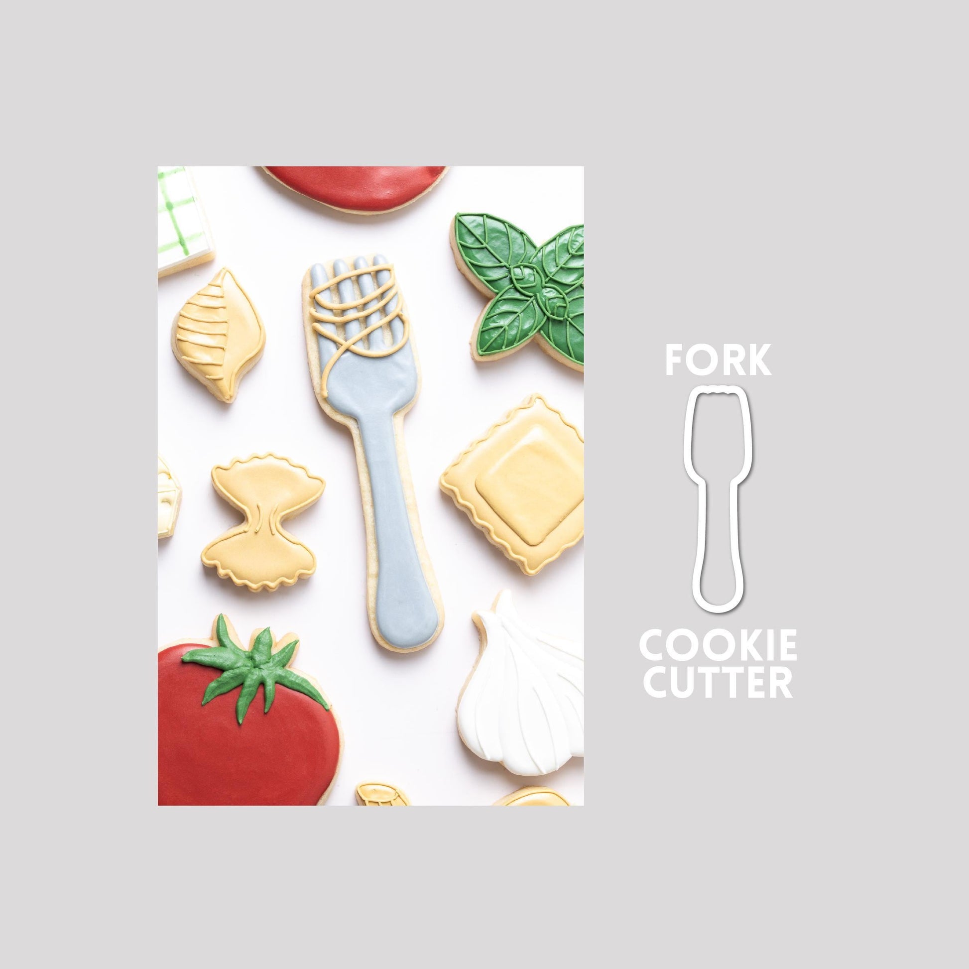 Decorated fork sugar cookie next to a fork cookie cutter outline on a gray background.