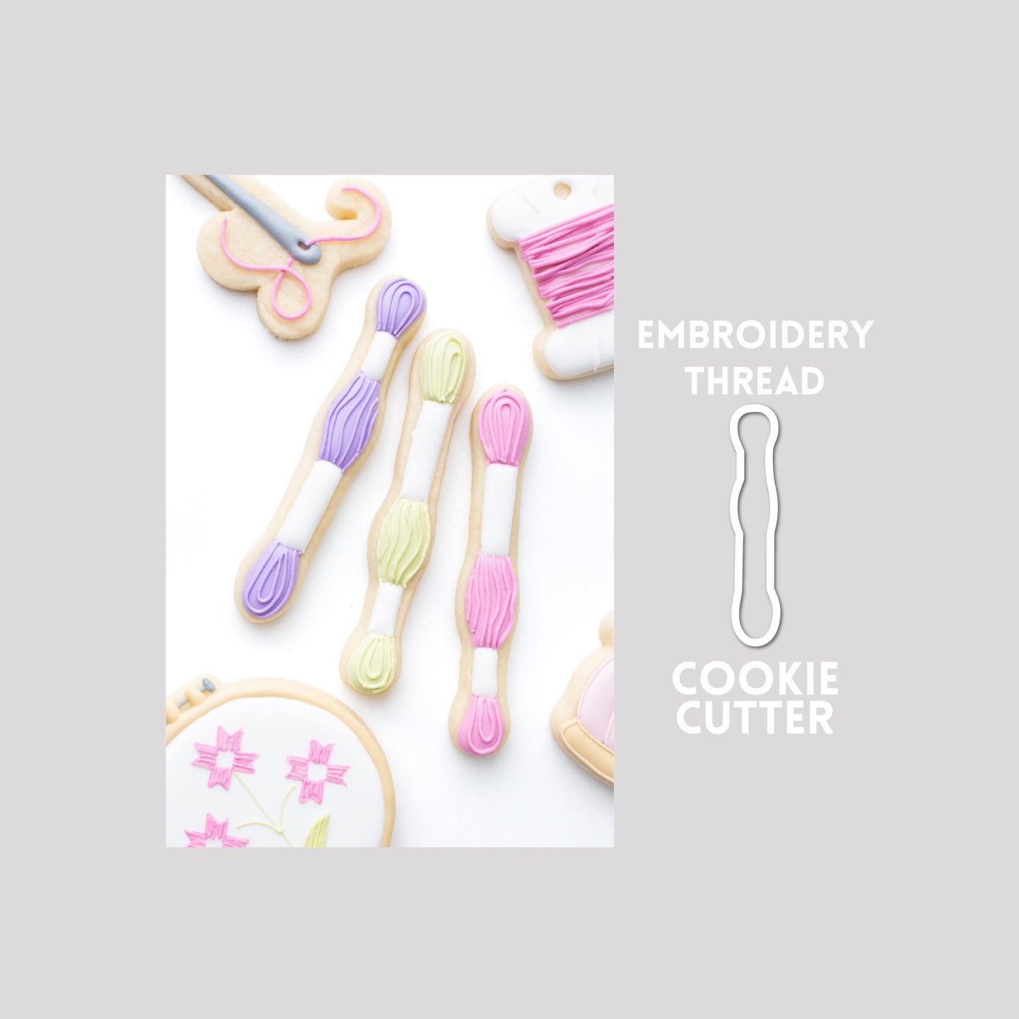 Decorated embroidery floss sugar cookie next to a embroidery floss cookie cutter outline on a gray background.