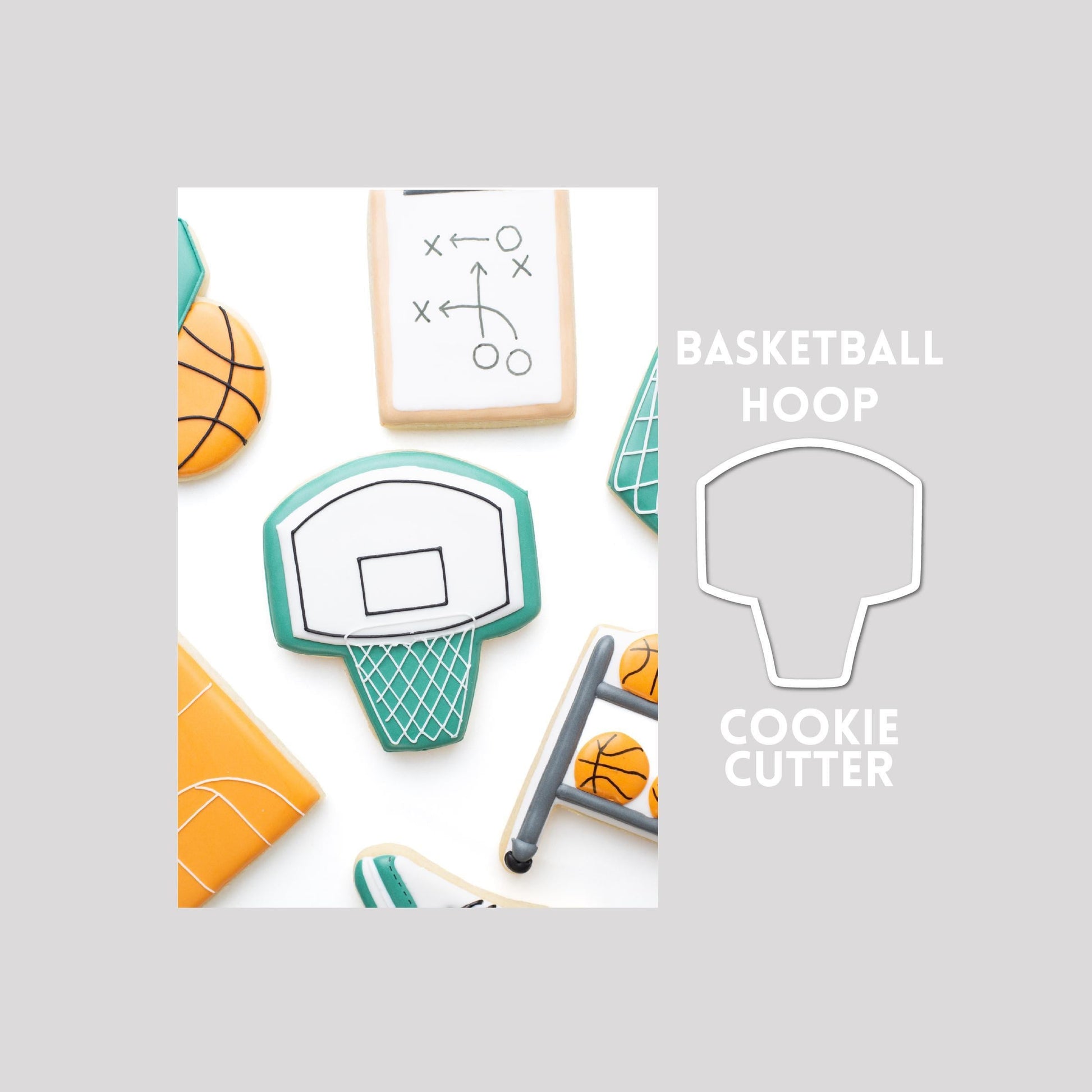 Decorated basketball hoop sugar cookie next to a basketball hoop cookie cutter outline on a gray background.