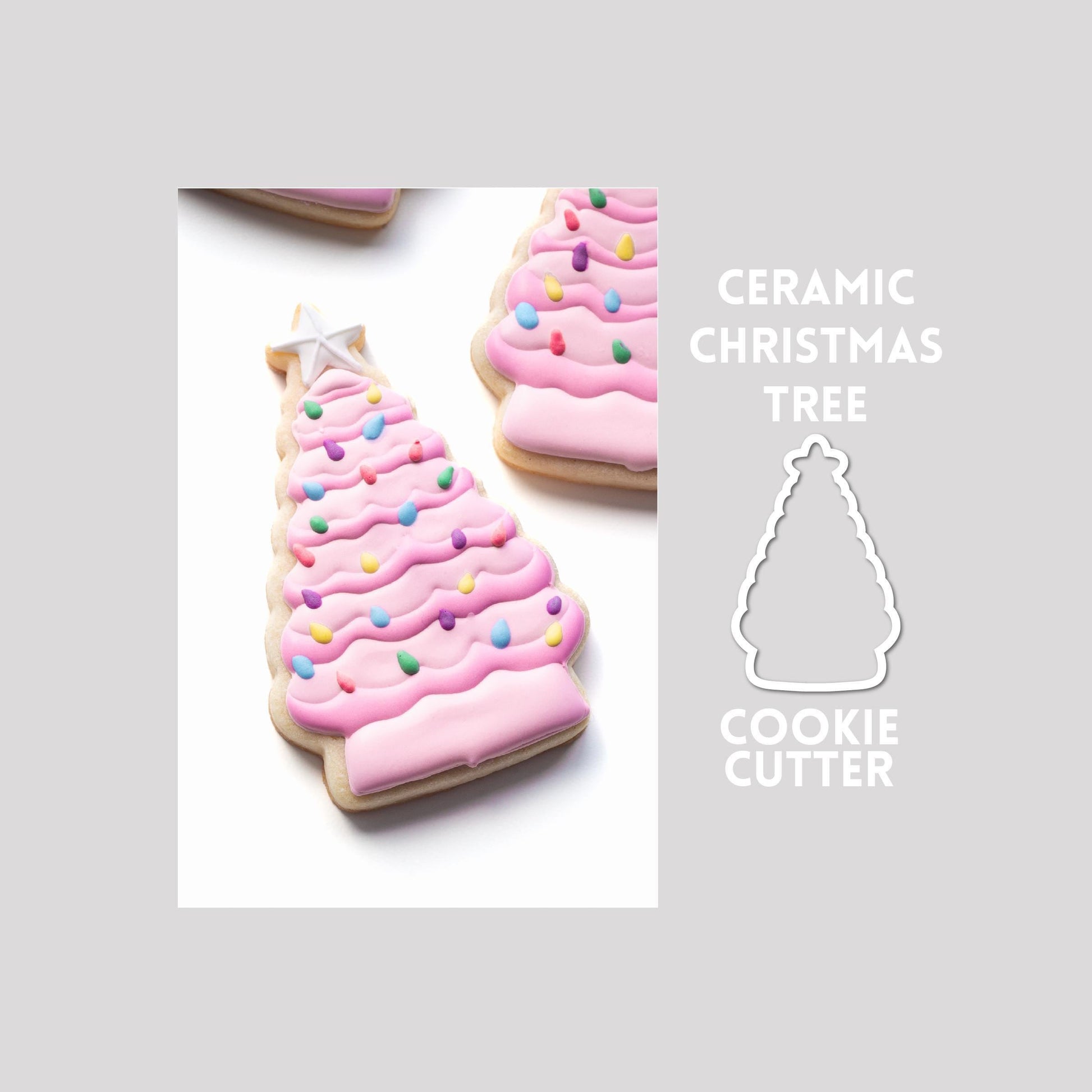 Decorated ceramic christmas tree sugar cookie next to a ceramic christmas tree cookie cutter outline on a gray background.