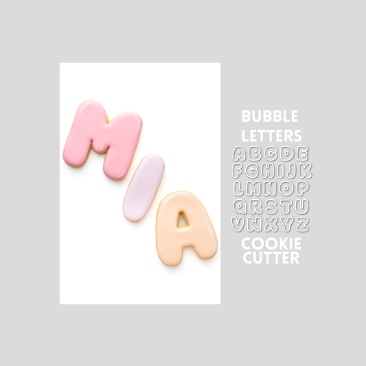 Decorated bubble letters sugar cookie next to a bubble letters cookie cutter outline on a gray background.