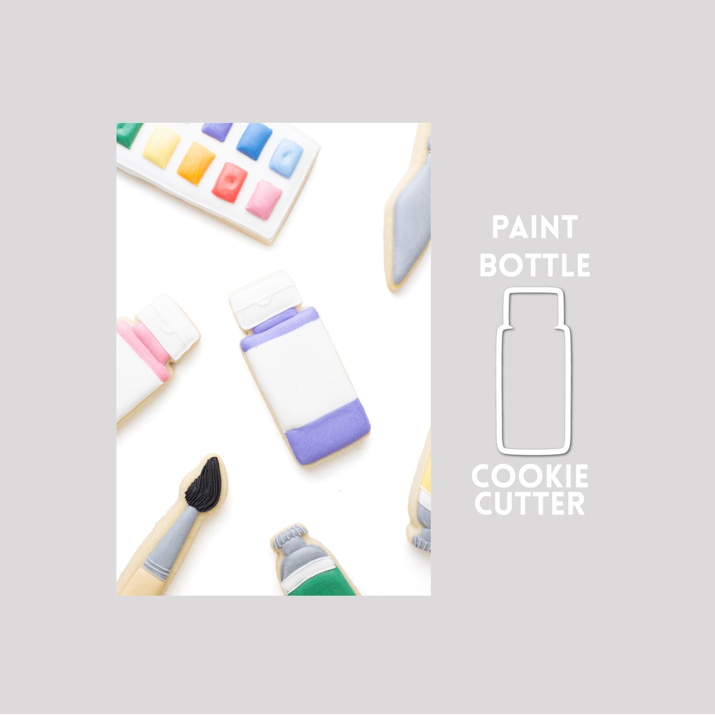 Decorated paint bottle sugar cookie next to a paint bottle cookie cutter outline on a gray background.