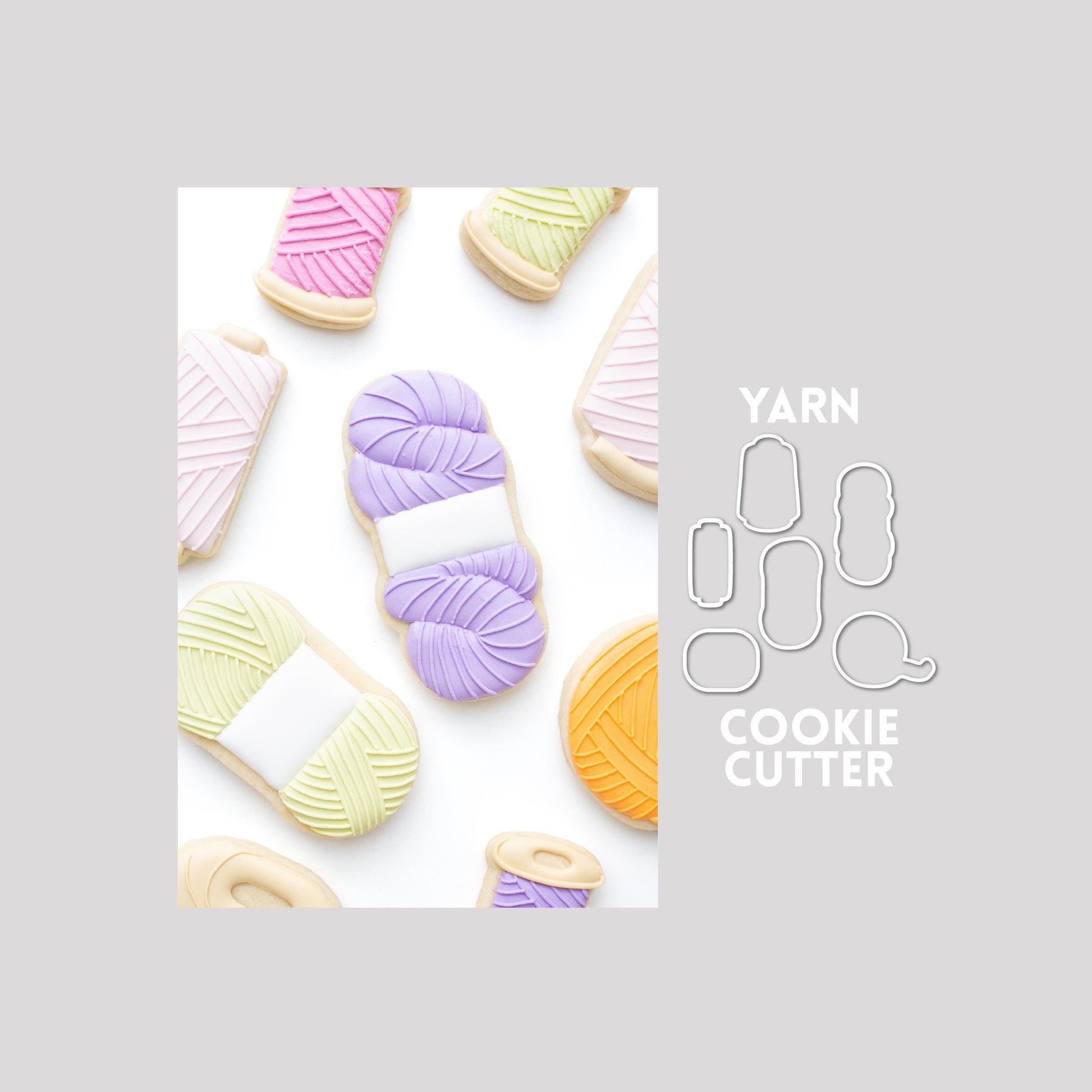 Decorated yarn sugar cookies next to a yarn cookie cutter outlines on a gray background.