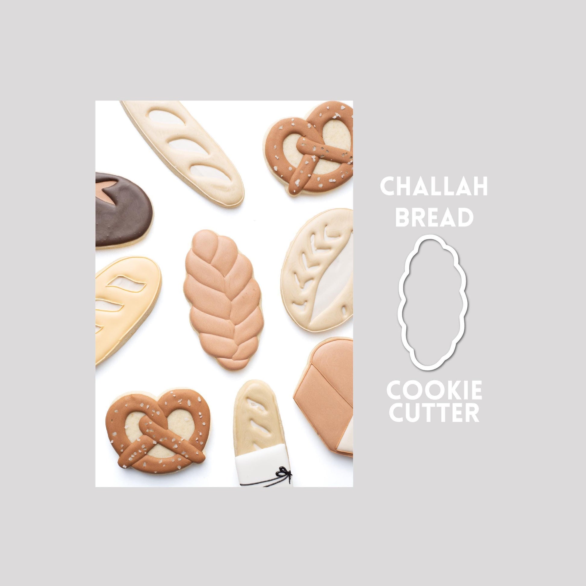 Decorated challah bread sugar cookie next to a challah bread cookie cutter outline on a gray background.