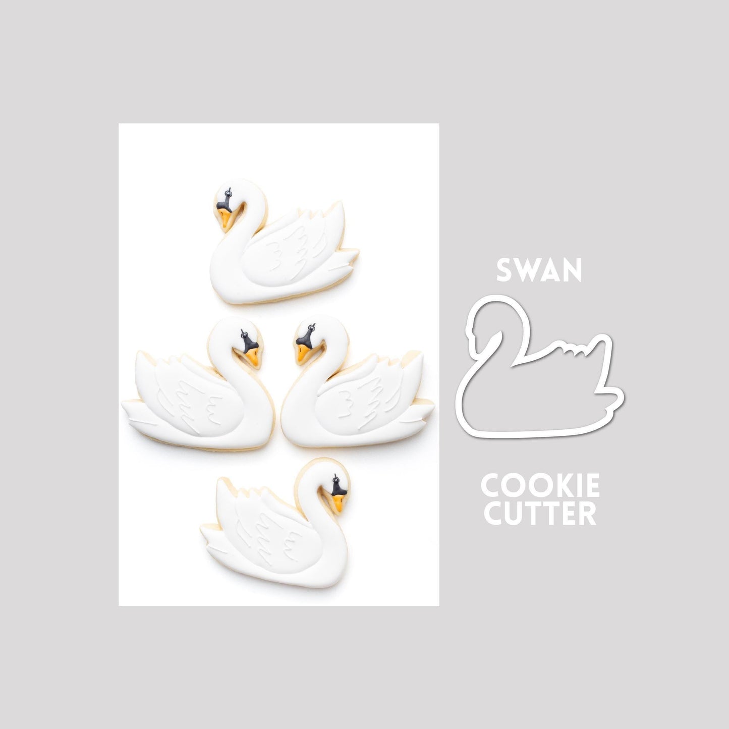 Decorated swan sugar cookie next to a swan cookie cutter outline on a gray background.