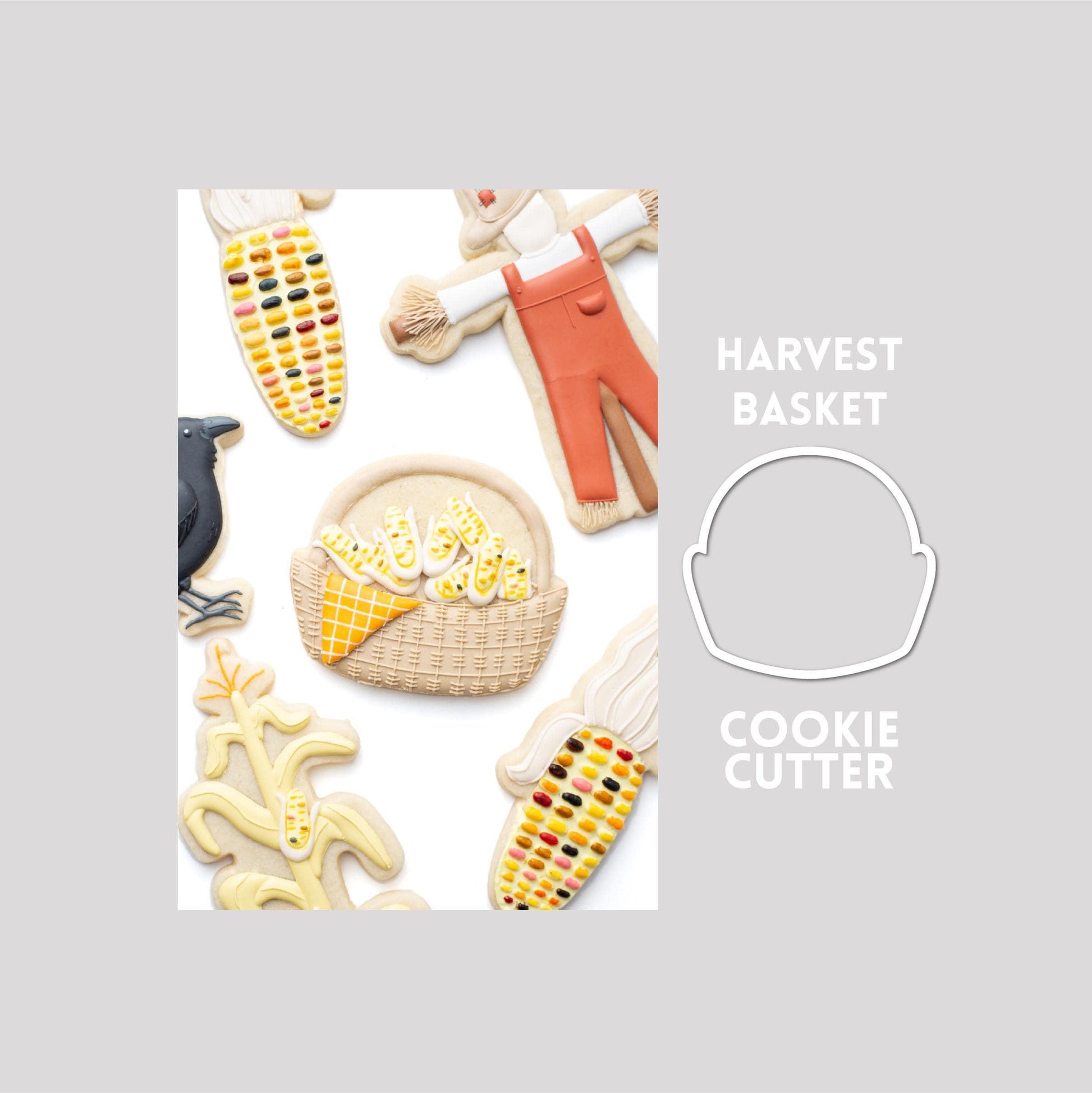 Decorated harvest basket sugar cookie next to a harvest basket cookie cutter outline on a gray background.