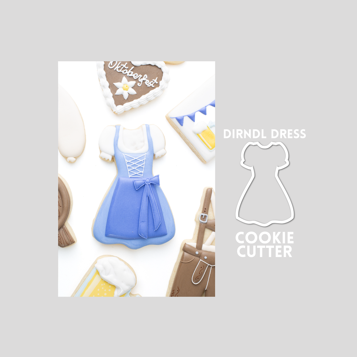 Decorated dirndl dress sugar cookie next to a dirndl cookie cutter outline on a gray background.