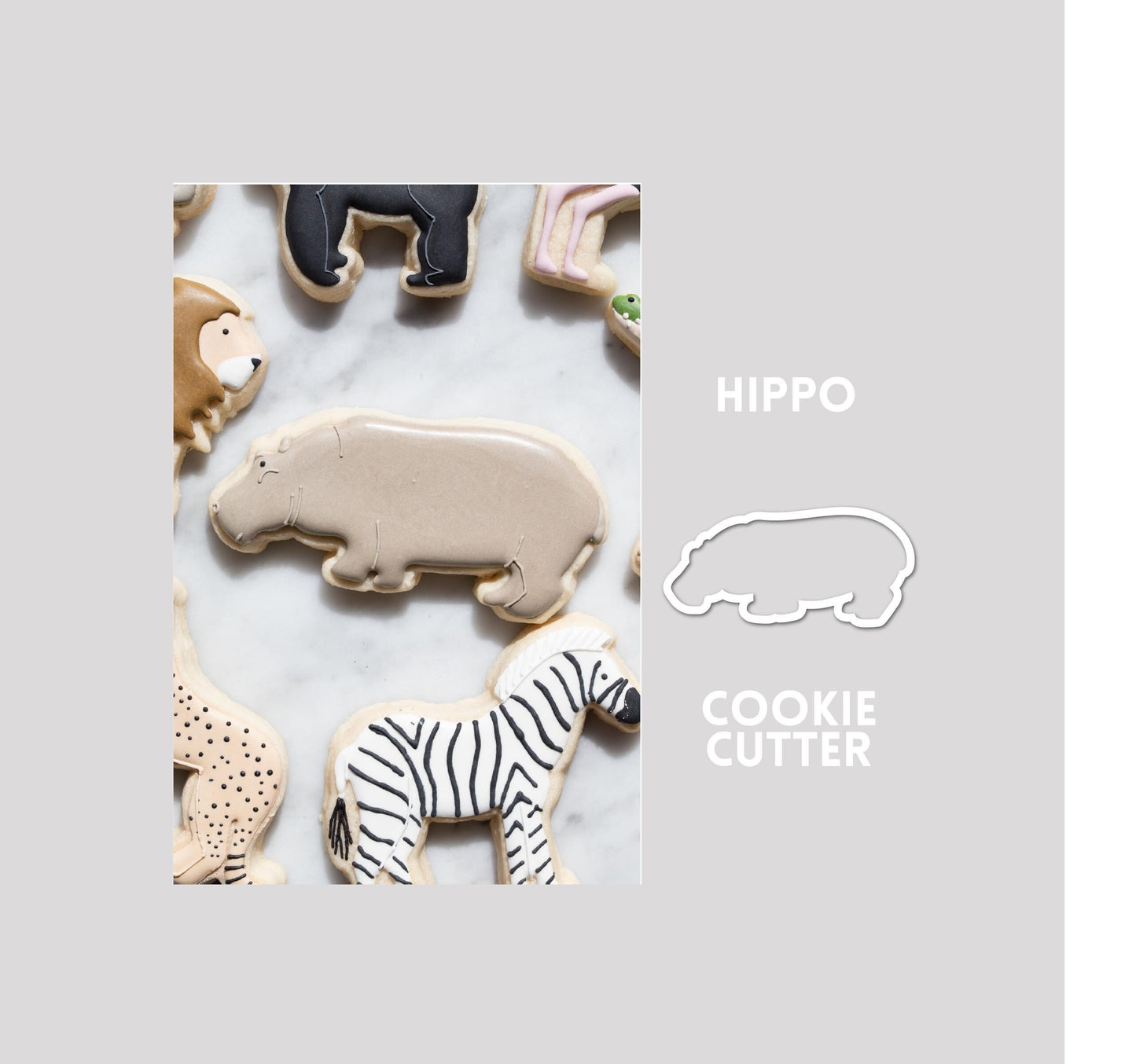 Decorated hippo sugar cookie next to a hippo cookie cutter outline on a gray background.