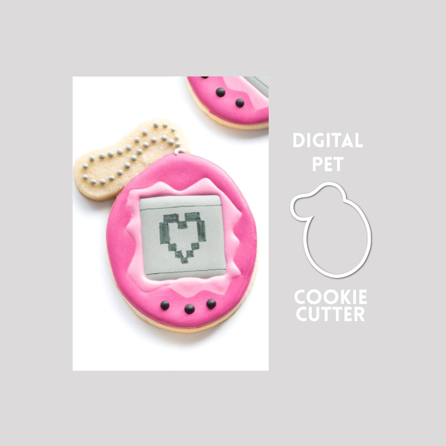 Decorated digital pet sugar cookie next to a digital pet cookie cutter outline on a gray background.