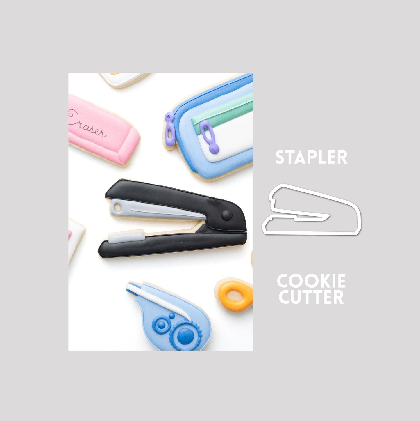 Decorated stapler sugar cookie next to a stapler cookie cutter outline on a gray background.
