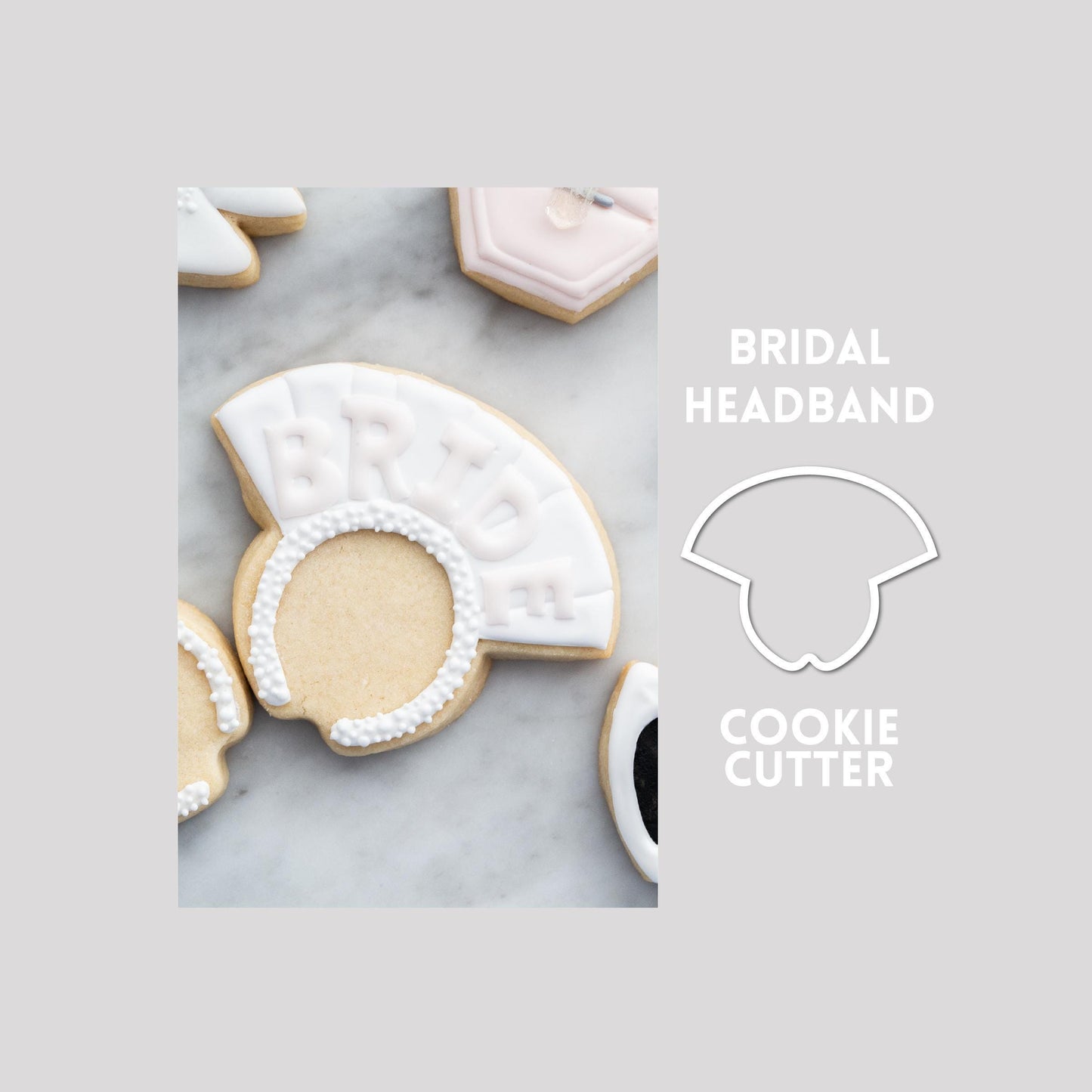 Decorated bridal headband sugar cookie next to a bridal headband cookie cutter outline on a gray background.