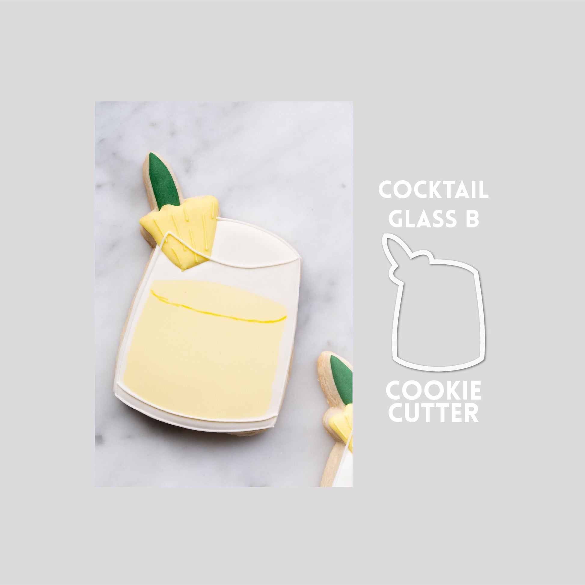 Decorated cocktail glass with a pineapple sugar cookie next to a cocktail glass with pineapple cookie cutter outline on a gray background.
