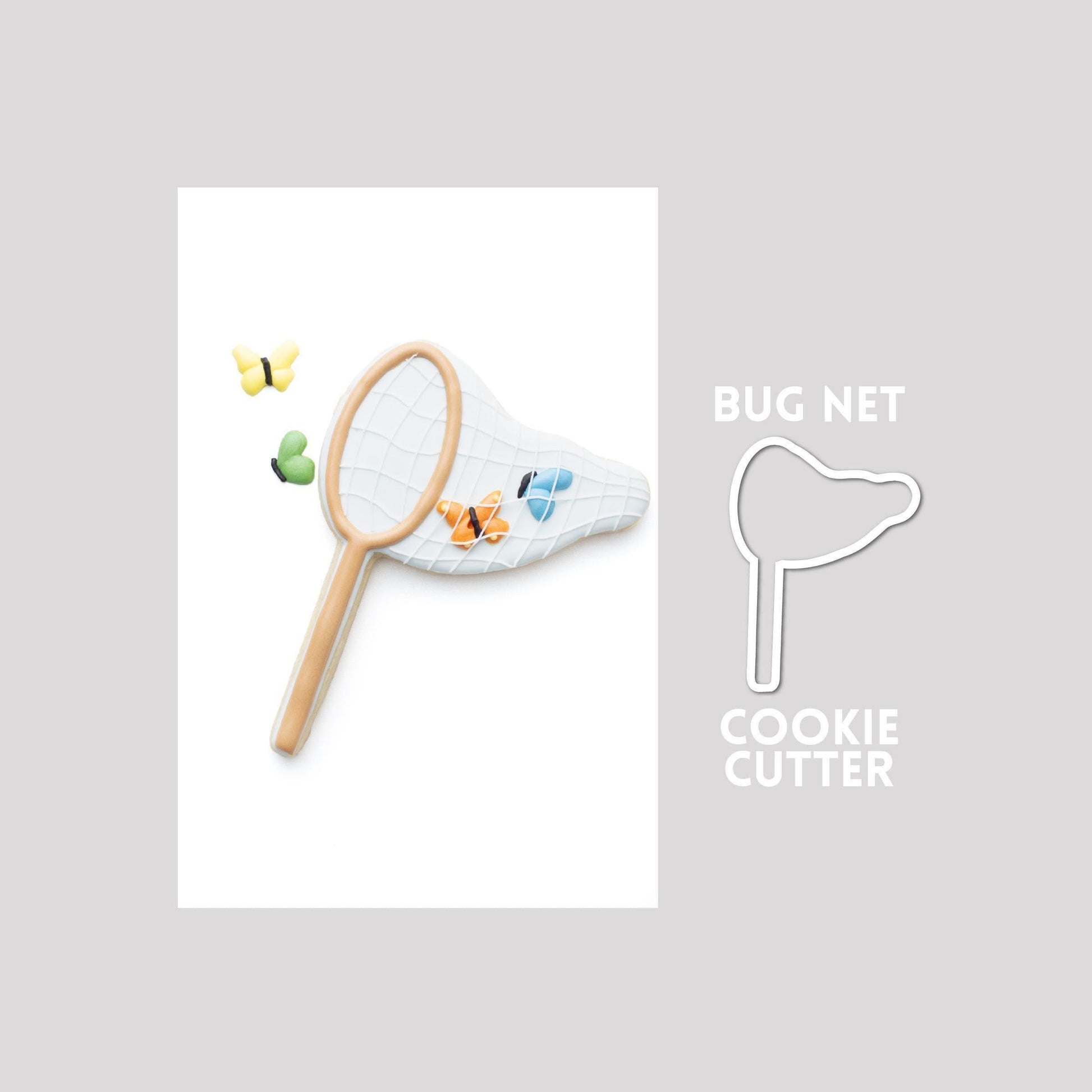 Decorated bug net sugar cookie next to a bug net cookie cutter outline on a gray background.