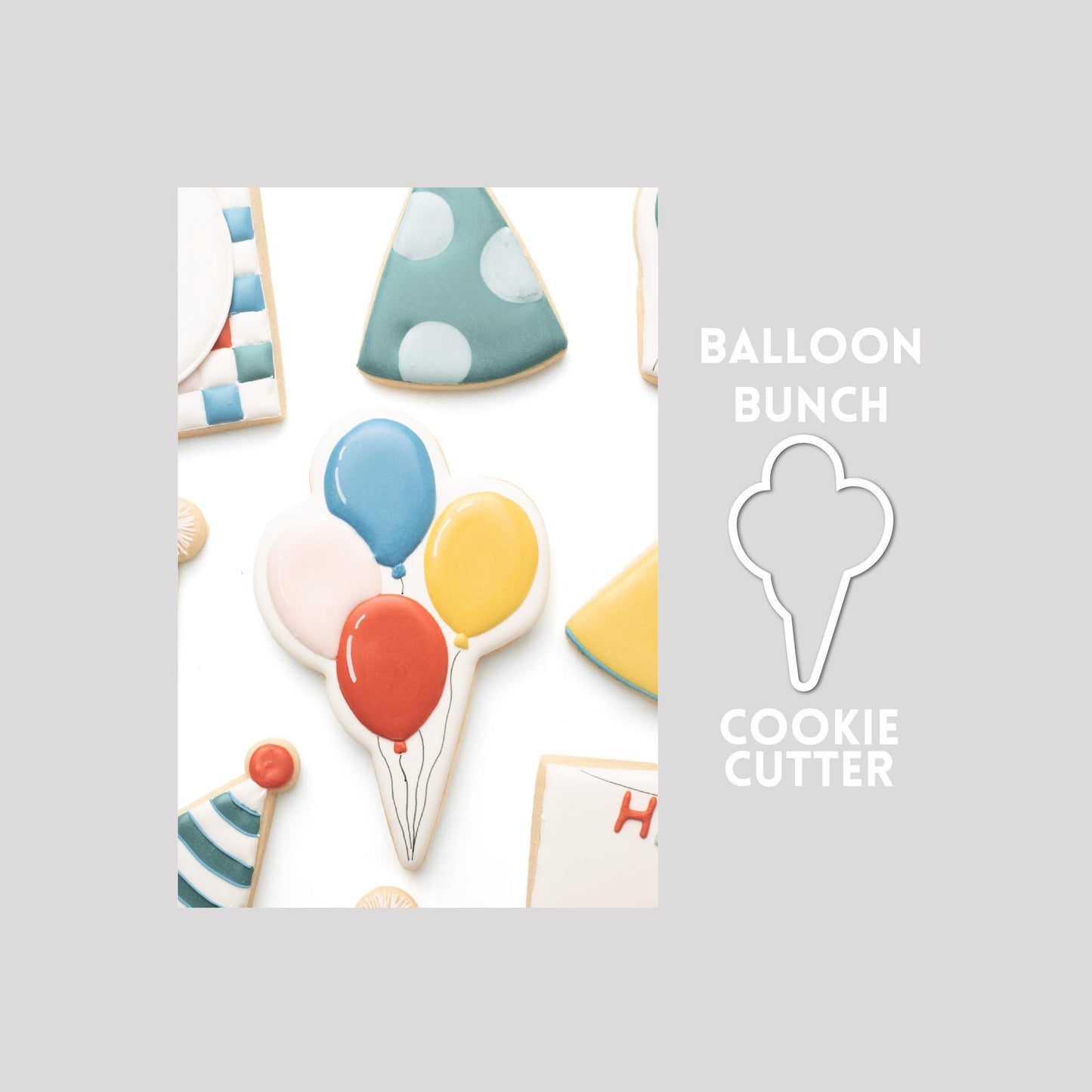 Decorated balloon bunch sugar cookie next to a balloon bunch cookie cutter outline on a gray background.