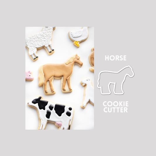 Decorated horse sugar cookie next to a horse cookie cutter outline on a gray background.