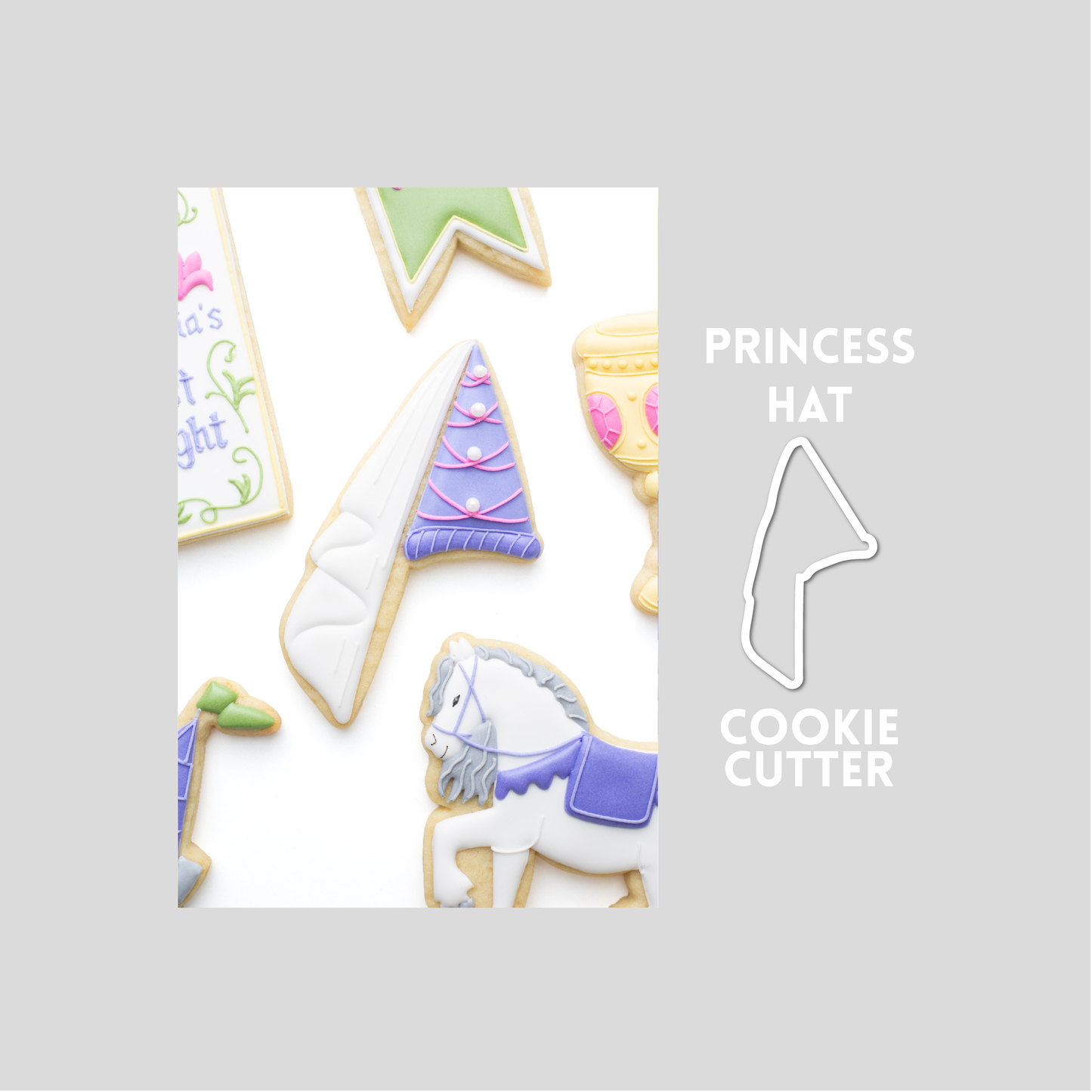 Decorated princess hat sugar cookie next to a princess hat cookie cutter outline on a gray background.