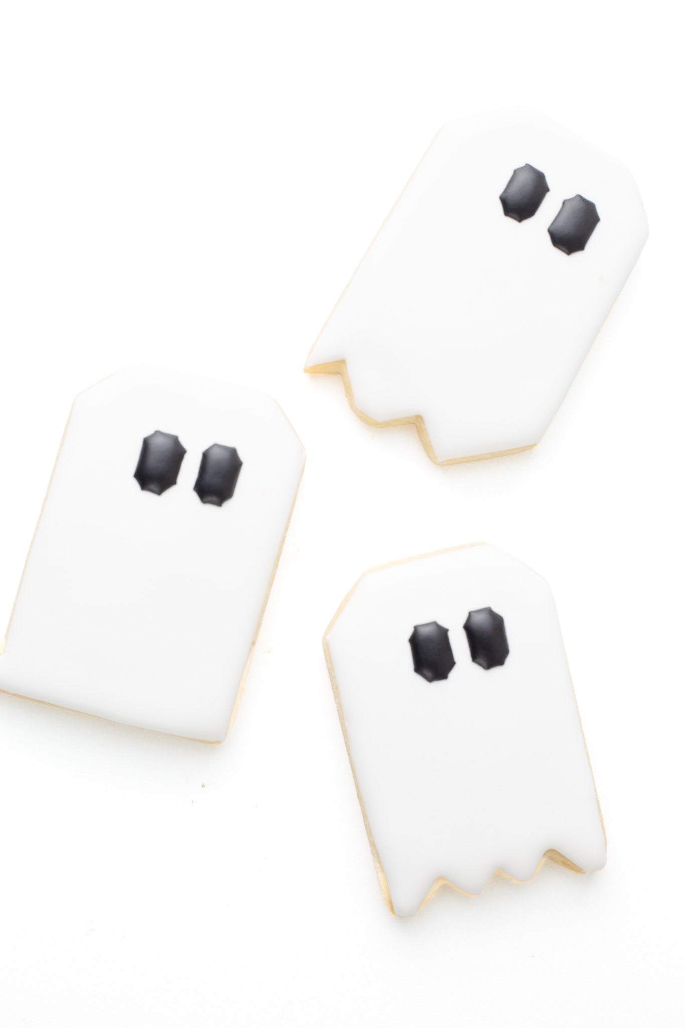 Quilt block ghost shaped decorated sugar cookies.